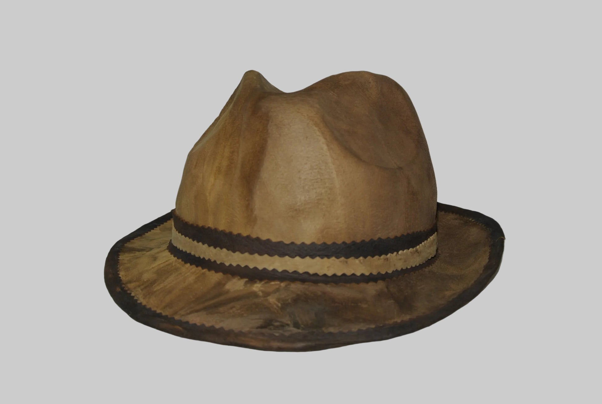 Brown fedora amadou hat with a black band against a plain background