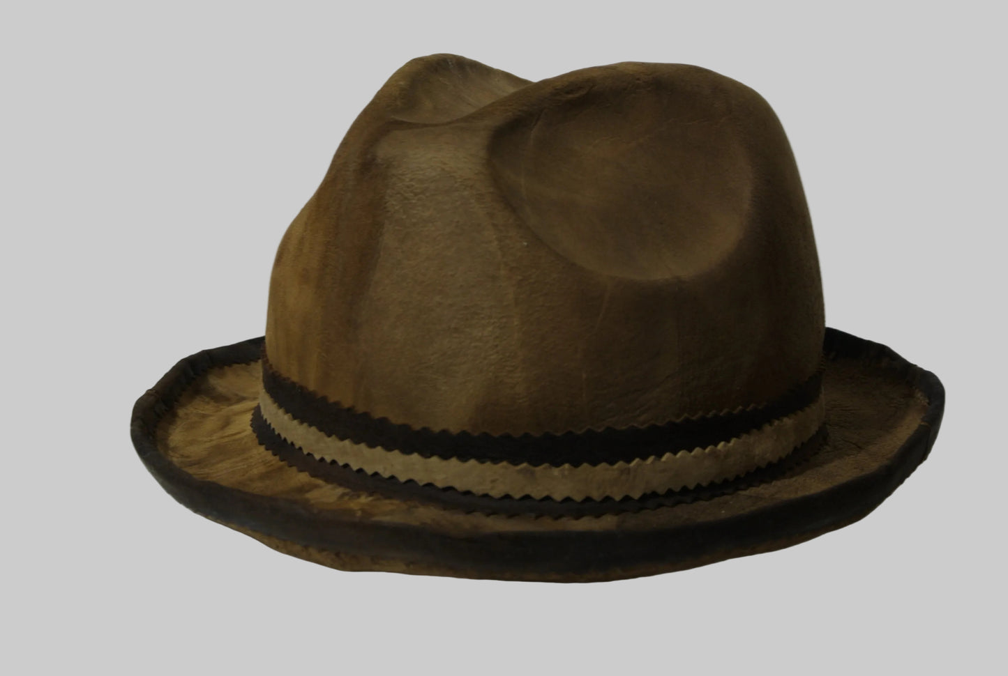 Brown amadou fedora hat with a black band on a white background