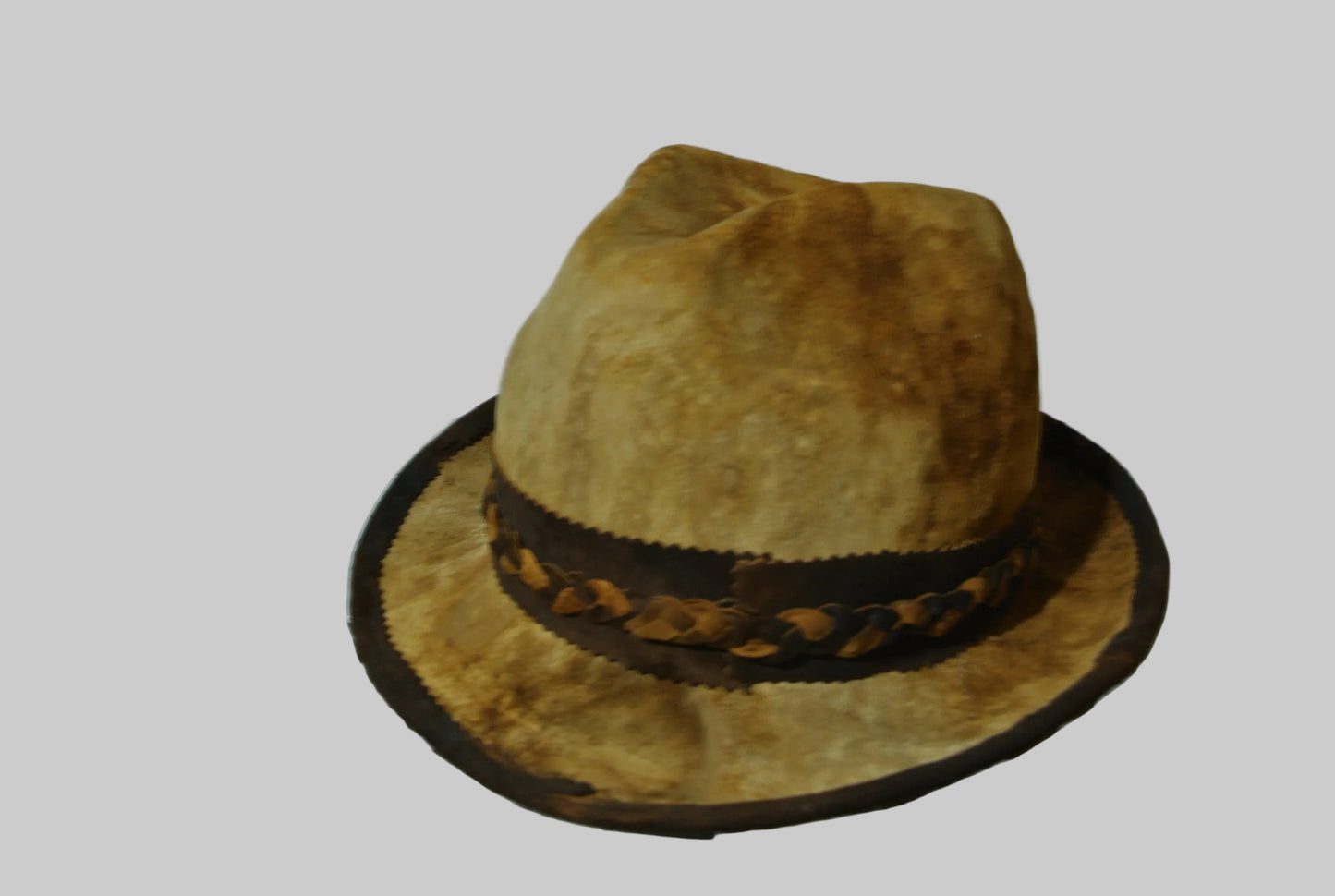 Brown amadou fedora hat with a decorative bandagainst a white background