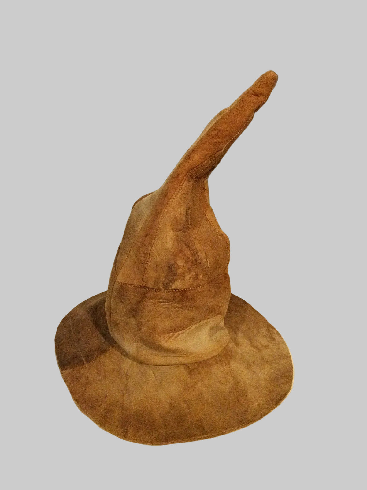 Brown amadou witch hat against white  background