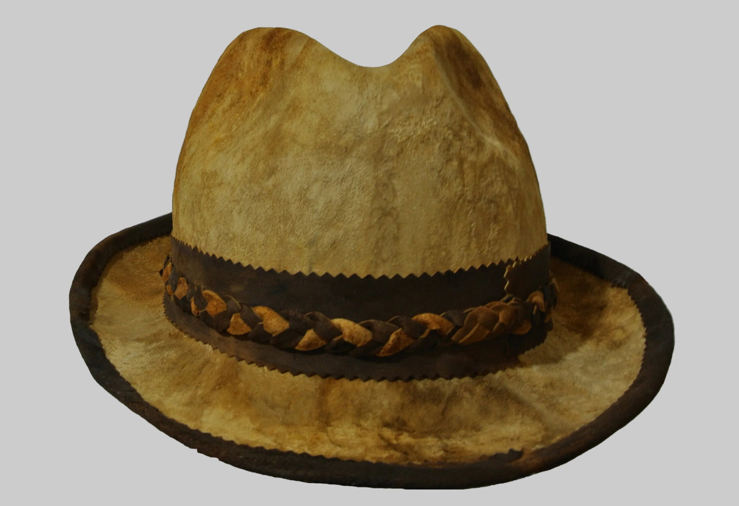 Brown amadou fedora hat with braided band on a white background